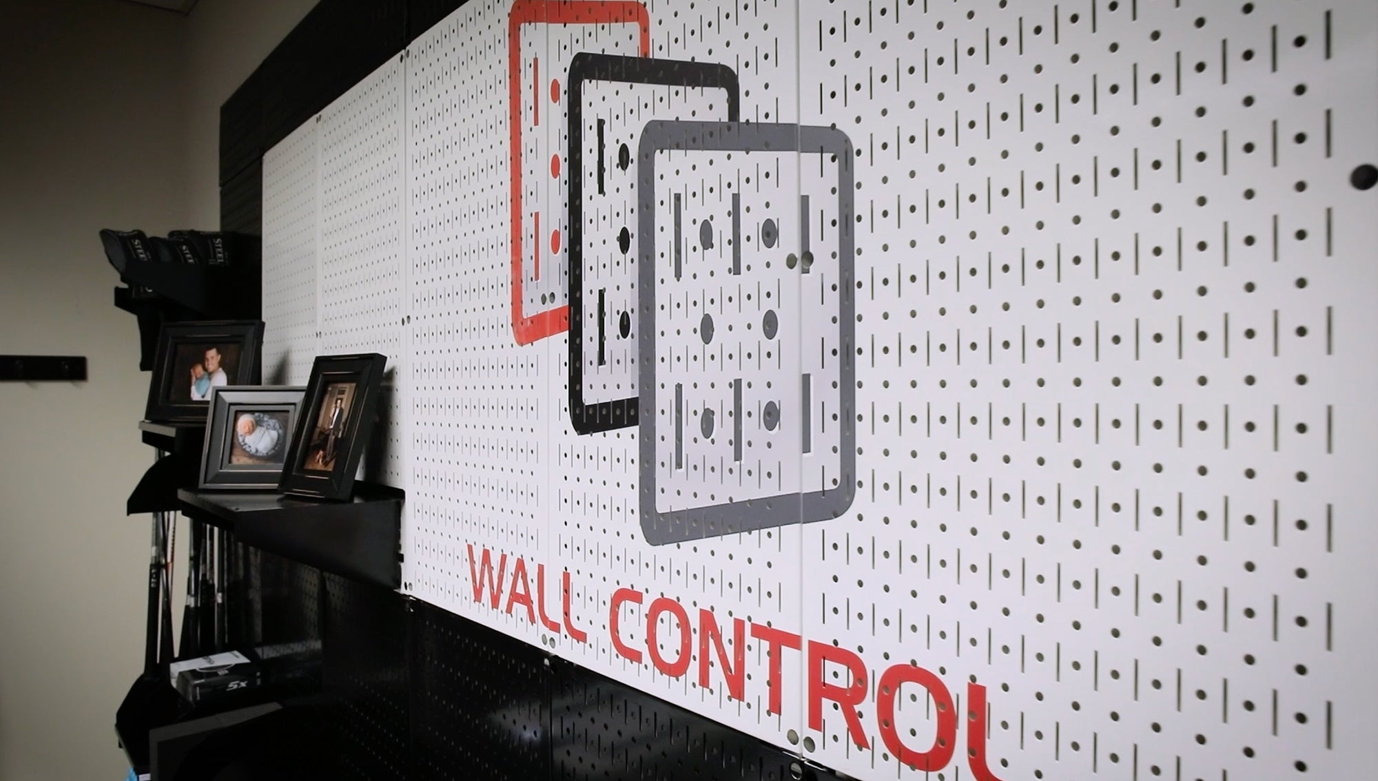 Pegboard wall with 'Wall Control' branding and decorative elements.