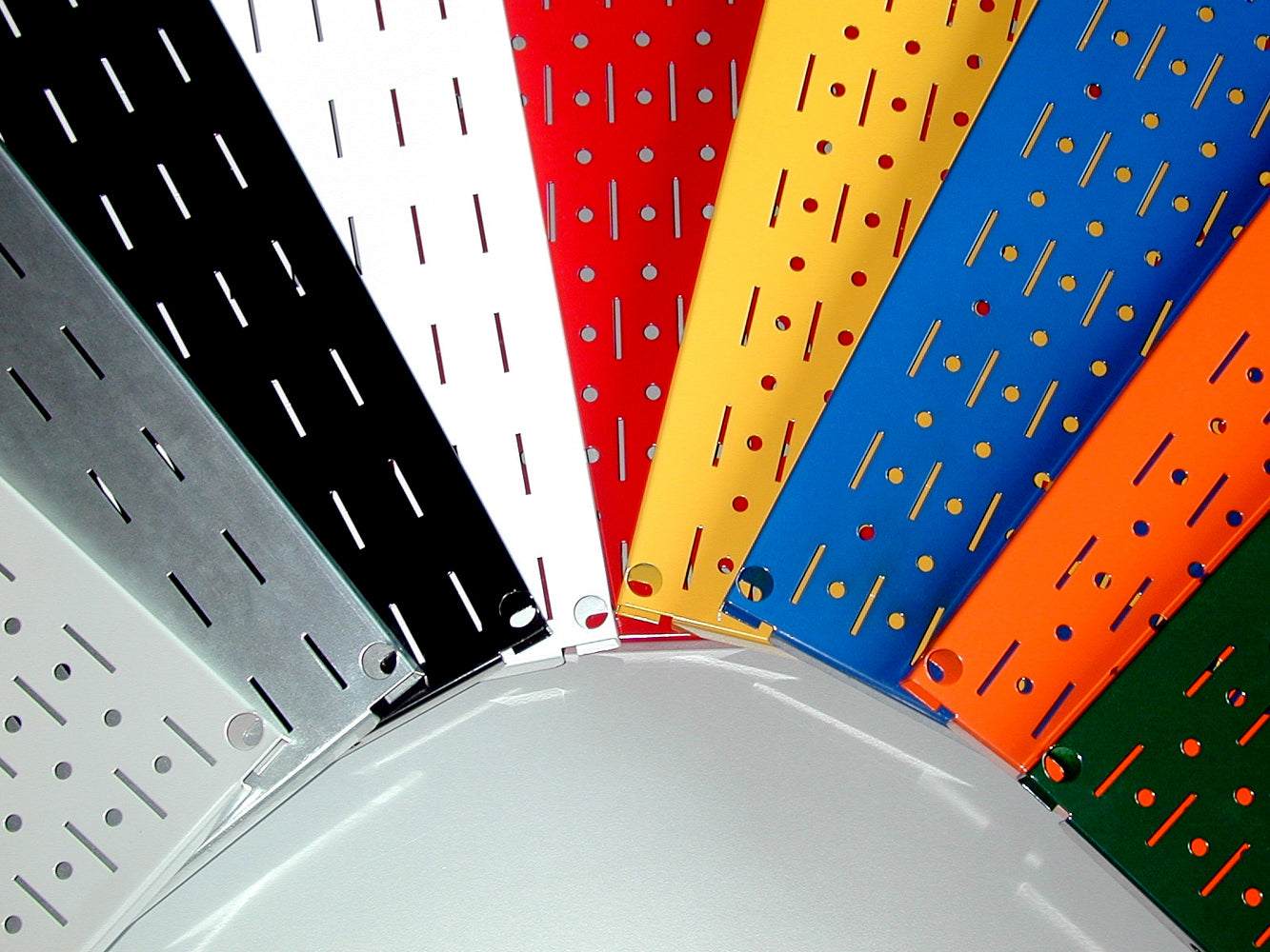 Colorful pegboards with different patterns arranged in a circular pattern.